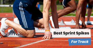 sprinter in blocks at track wearing spikes